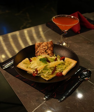 Freshly prepared Caesar salad featuring crisp romaine lettuce, creamy dressing, croutons, and shaved Parmesan. Enjoy this delightful dish at De Flambe, a top-rated restaurant in Islamabad, perfect for casual dining and family-friendly gatherings.