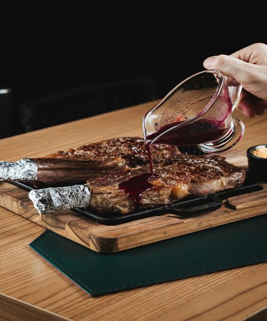 Tomahawk Pakistani Heritage at De Flambe, Elysium Tower, Blue Area, Islamabad. A traditional, flavor-packed Tomahawk steak infused with authentic Pakistani spices, expertly grilled and served with heritage-inspired sides. A must-try for steak lovers in F7, F8, G7, and G8 areas of Islamabad.