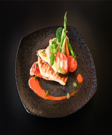 Parmigiana Chicken at De Flambe, a top-rated restaurant in Islamabad near Centaurus and PIMS Hospital. Enjoy a perfectly breaded and fried chicken breast, topped with rich marinara sauce and melted cheese, ideal for Italian cuisine lovers.