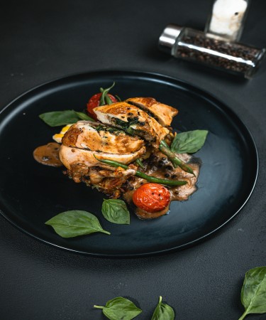 De Flambe Stuffed Chicken at De Flambe, a top-rated restaurant in Islamabad near Centaurus and PIMS Hospital. Delight in a perfectly cooked chicken breast stuffed with a savory filling, offering a rich blend of flavors, ideal for gourmet food lovers.