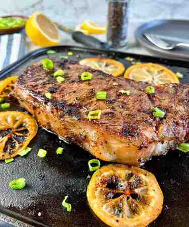 Lemon Honey Beef with glazed beef strips in a golden lemon-honey sauce, garnished with sesame seeds and herbs — served at DeFlambe, Blue Area, Elysium Tower, Islamabad, near Centaurus.